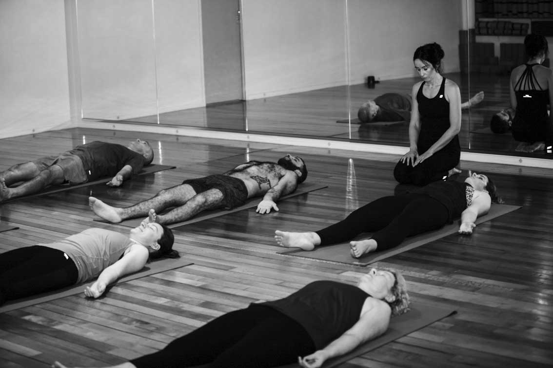 yoga class doing downward dog pose